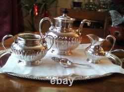 An ANTIQUE SILVER PLATED SELF POURING TEAPOT SET AND TRAY JAMES DIXON